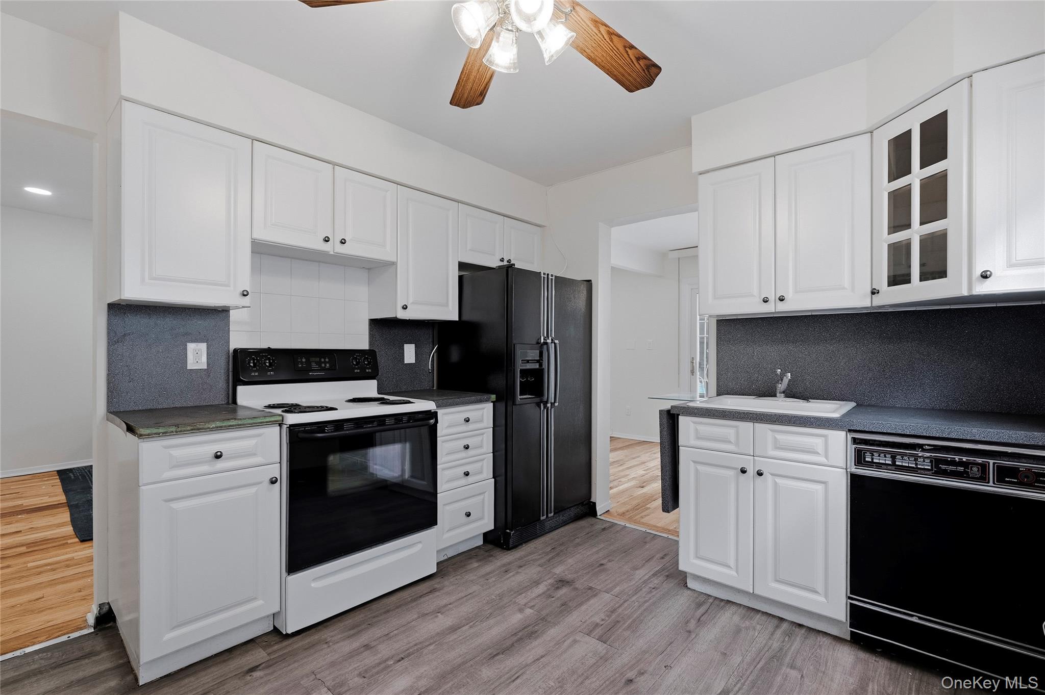 15-69 215th Street, Unit 1 Queens, NY 11360 - Photo 5 of 20 a kitchen with stainless steel appliances granite countertop a stove a sink and a refrigerator