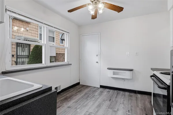 a view of room with window and wooden floor