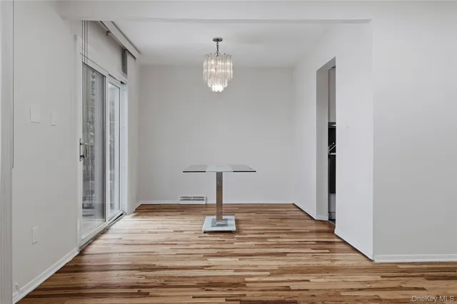 a view of a livingroom with wooden floor and a ceiling fan