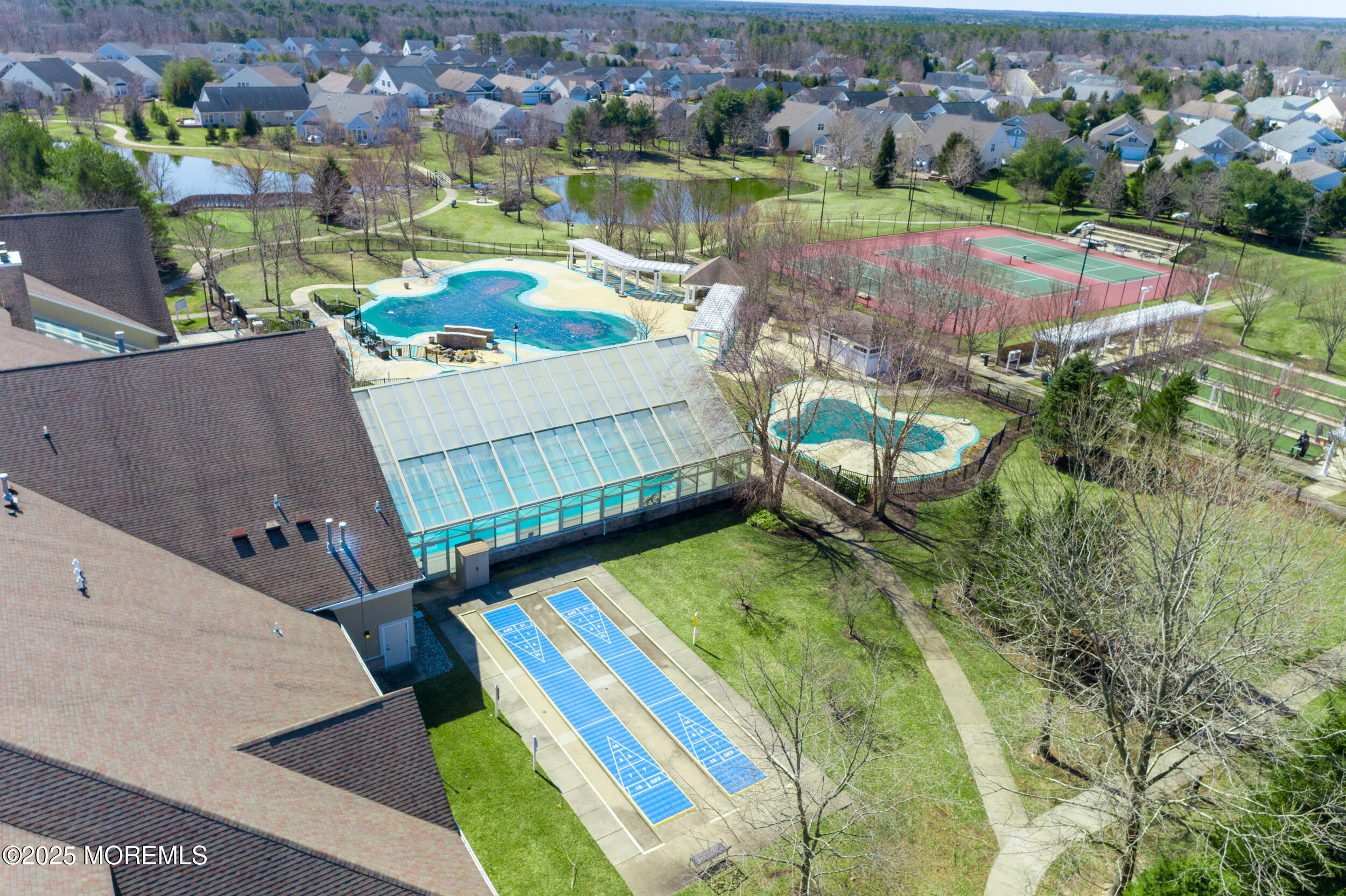 a view of a swimming pool with a patio and a garden