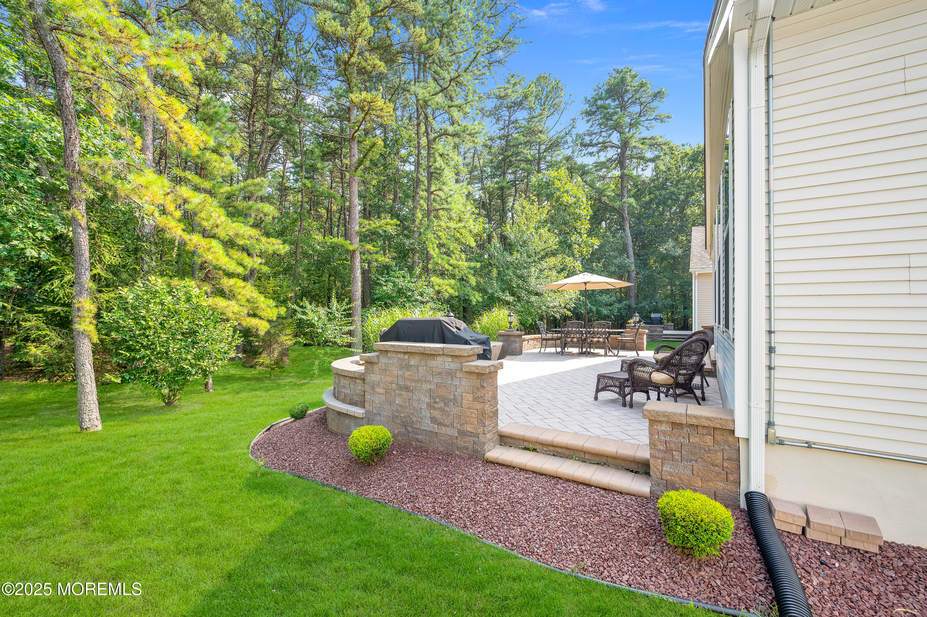 23 Lenox Road Jackson, NJ 08527 - Photo 19 of 35 a backyard of a house with table and chairs