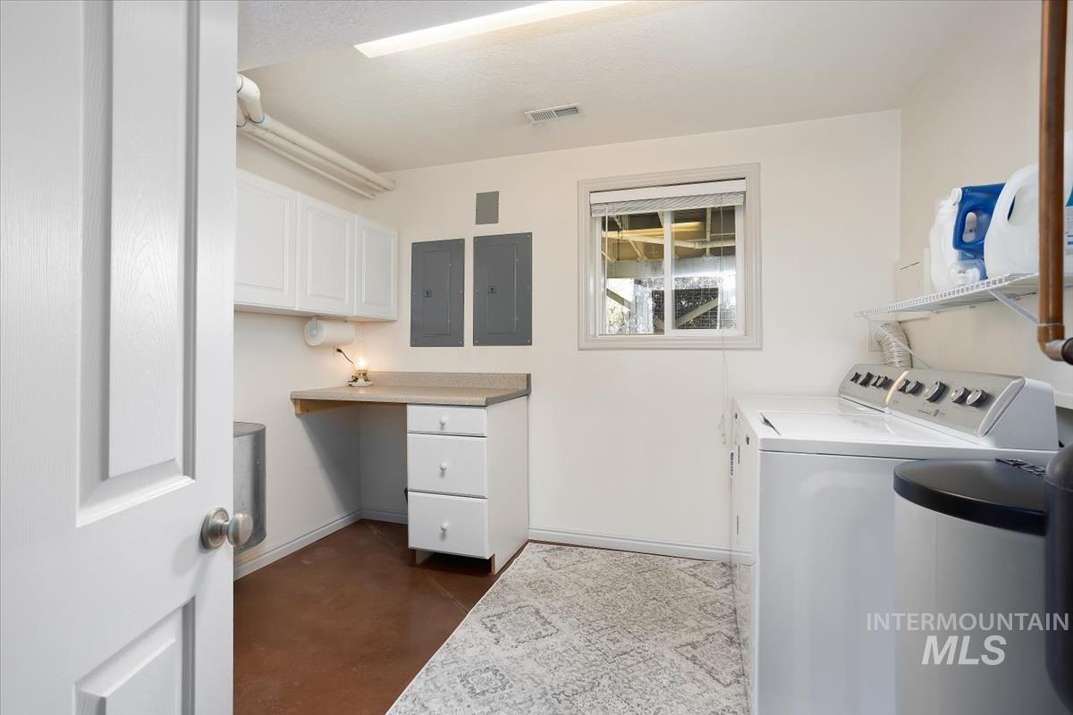 4870 North Farrow Street Boise, ID 83713 - Photo 20 of 40 Laundry room featuring concrete floors, electric panel, and washer and clothes dryer