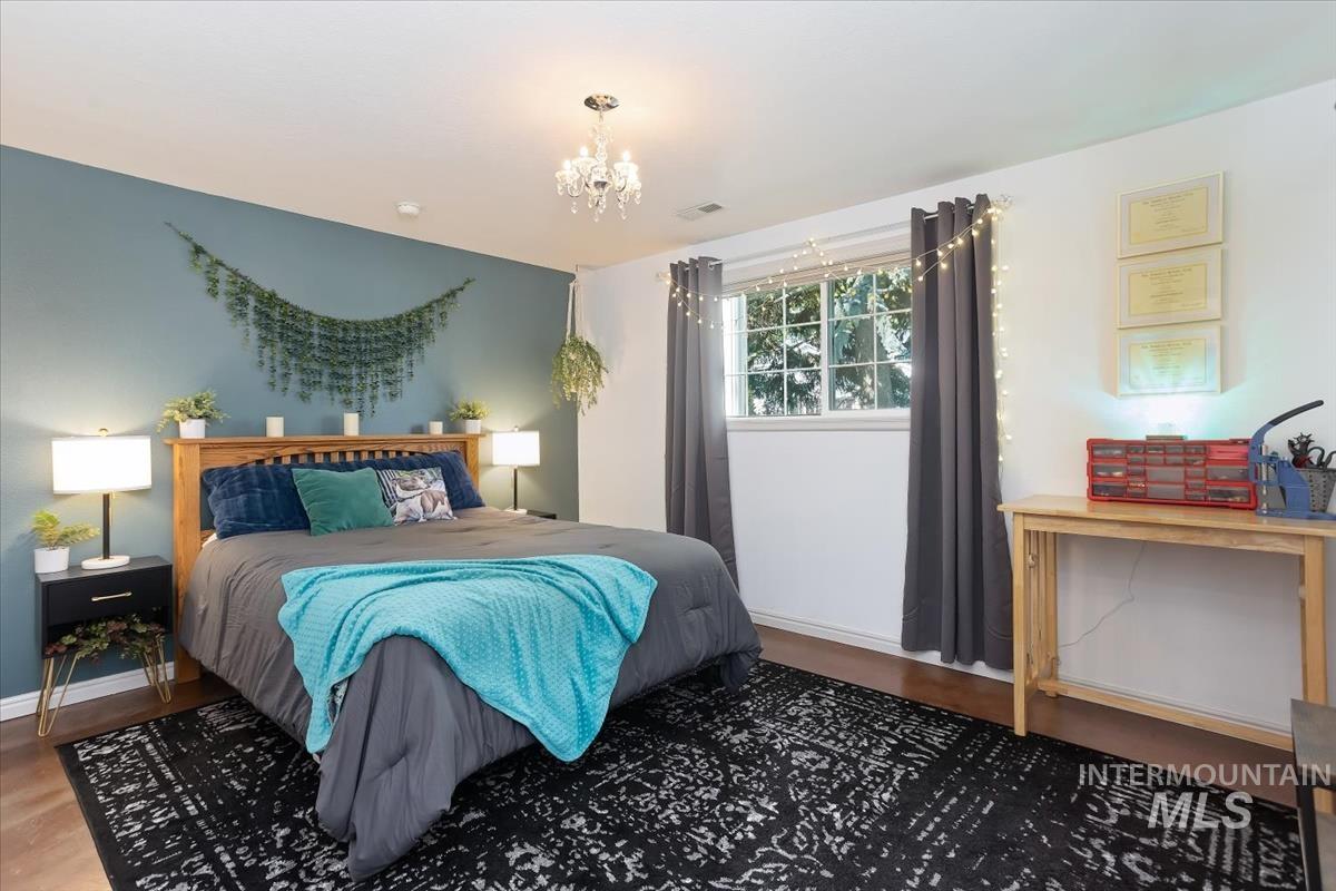 4870 North Farrow Street Boise, ID 83713 - Photo 22 of 40 Bedroom featuring suspended lighting and wood finished floors