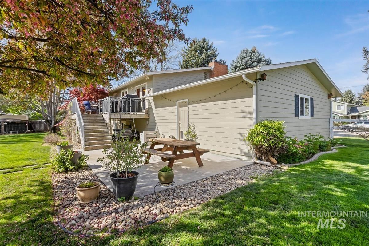 4870 North Farrow Street Boise, ID 83713 - Photo 24 of 40 Rear view of house with a lawn, a deck, a patio, and a chimney