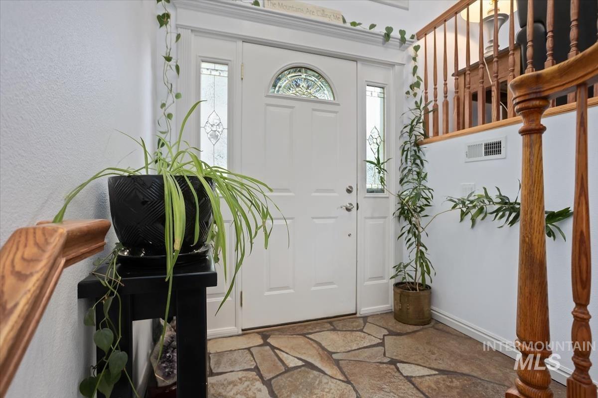 4870 North Farrow Street Boise, ID 83713 - Photo 4 of 40 Entryway with baseboards and light stone finish flooring