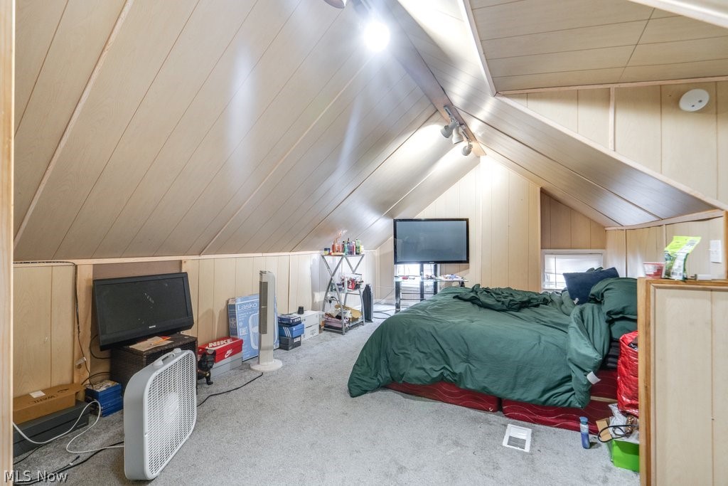3418 Altamont Road Cleveland, OH 44118 - Photo 14 of 24 Bedroom featuring vaulted ceiling, wood walls, and carpet