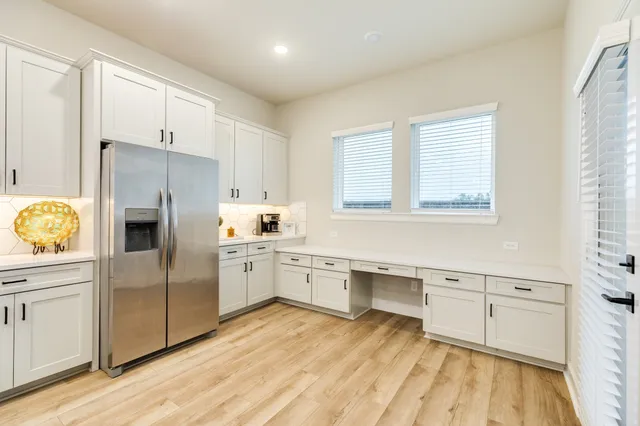 a kitchen with counter top space a sink stainless steel appliances and cabinets