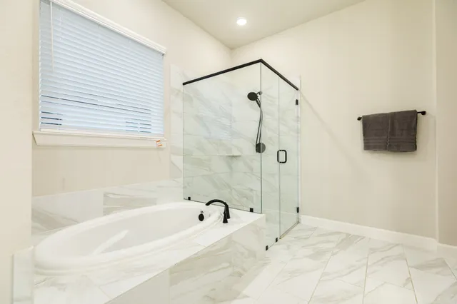 a bathroom with a bathtub and a shower