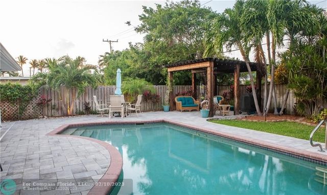 a view of a swimming pool and lounge chair