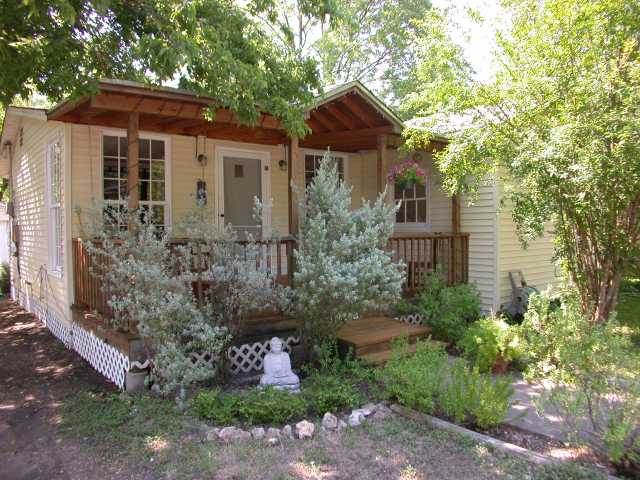 a front view of a house with plants