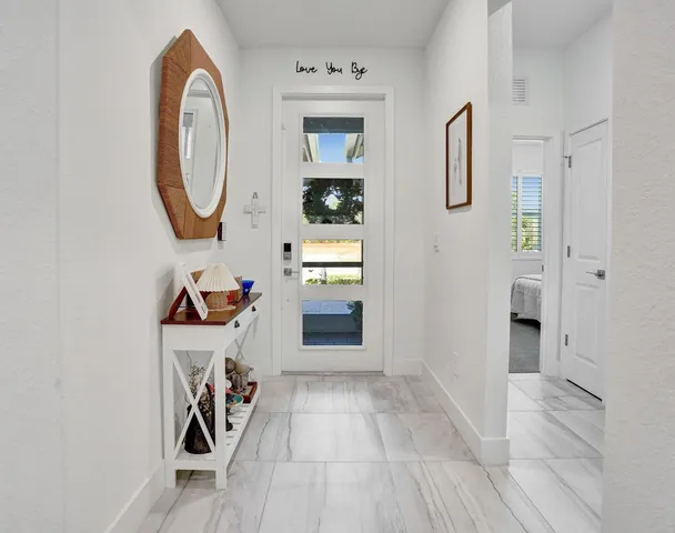 a view of a livingroom with an entryway and a fireplace