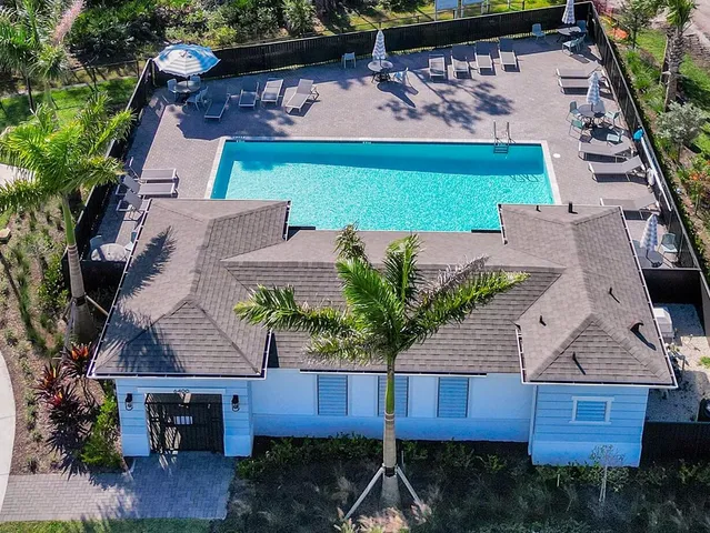 an aerial view of a house with yard and lake view