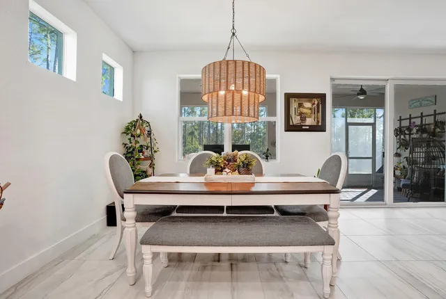 a view of a dining room with furniture and chandelier