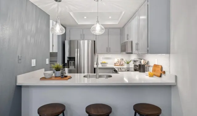 a kitchen with appliances a sink and cabinets