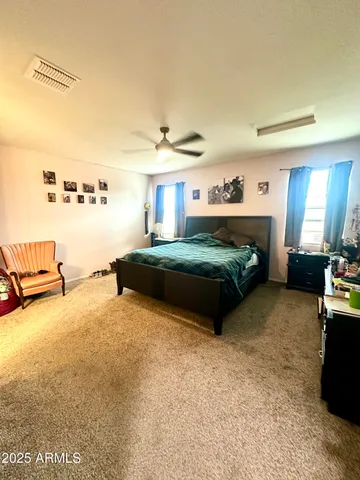 a bedroom with bed and window