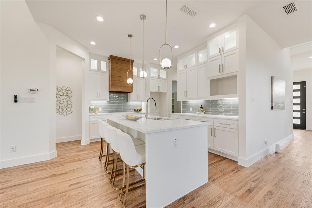 539 West Laureland Road Dallas, TX 75232 - Photo 14 of 37 a kitchen with kitchen island a sink stove and white cabinets