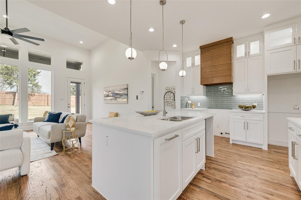 539 West Laureland Road Dallas, TX 75232 - Photo 18 of 37 a kitchen with a sink stove and wooden floor