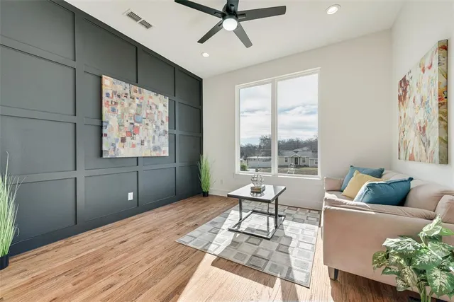 a living room with furniture and wooden floor