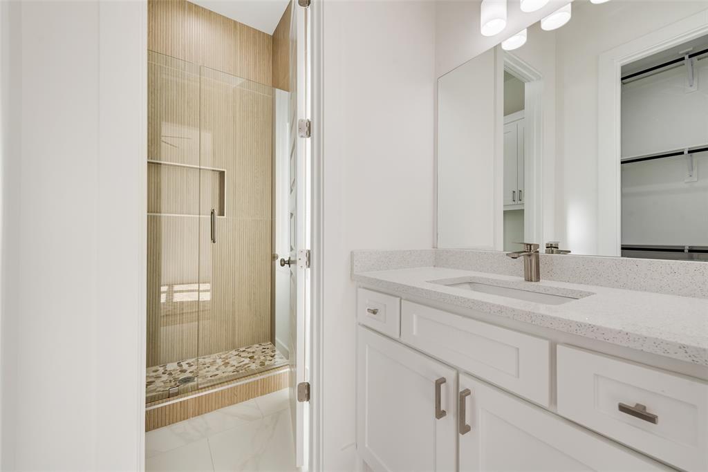 539 West Laureland Road Dallas, TX 75232 - Photo 31 of 37 a bathroom with a sink and a mirror