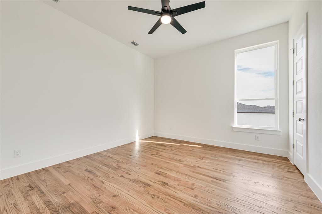 539 West Laureland Road Dallas, TX 75232 - Photo 32 of 37 an empty room with wooden floor and windows