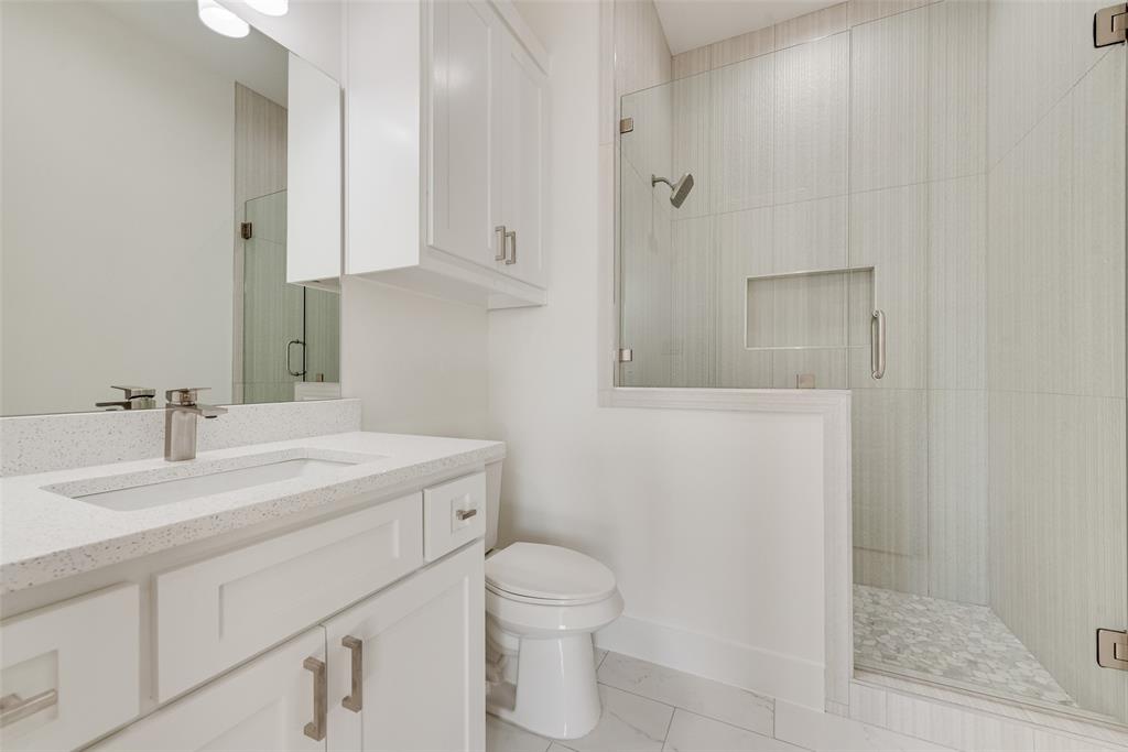 539 West Laureland Road Dallas, TX 75232 - Photo 33 of 37 a bathroom with a sink toilet vanity and shower