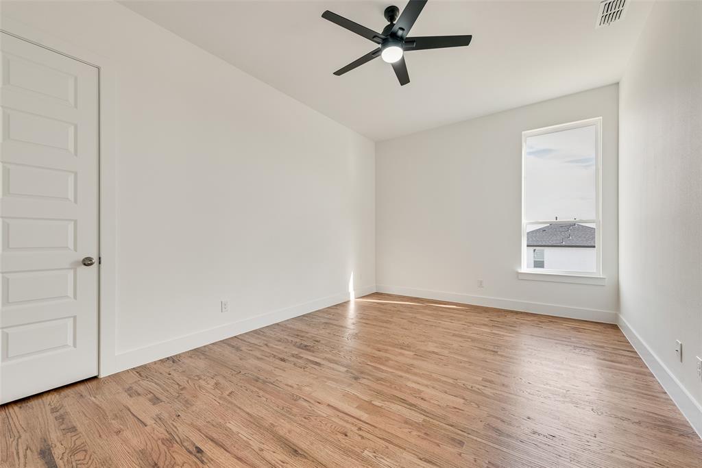 539 West Laureland Road Dallas, TX 75232 - Photo 34 of 37 an empty room with wooden floor fan and windows