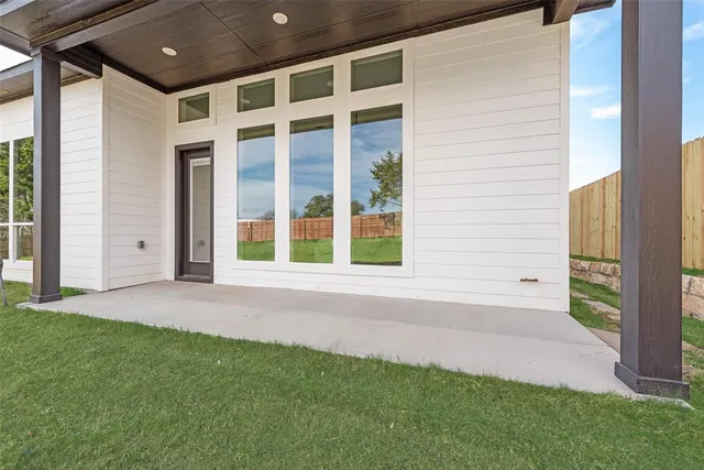a view of a field of grass and trees