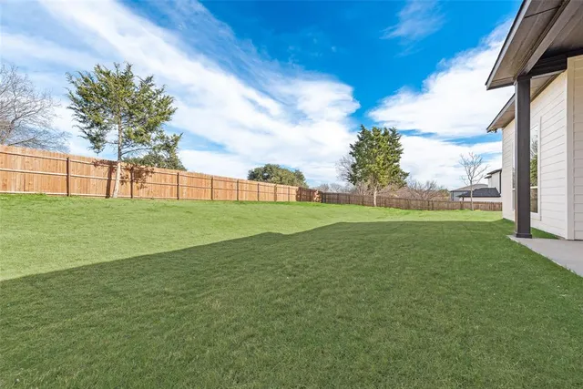a backyard of a house with large trees