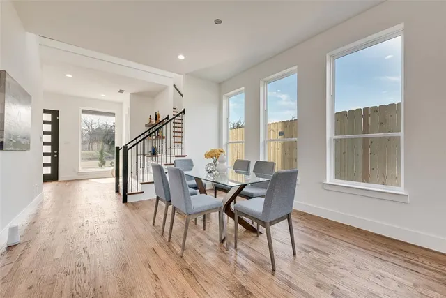 a dining room with furniture entryway and wooden floor