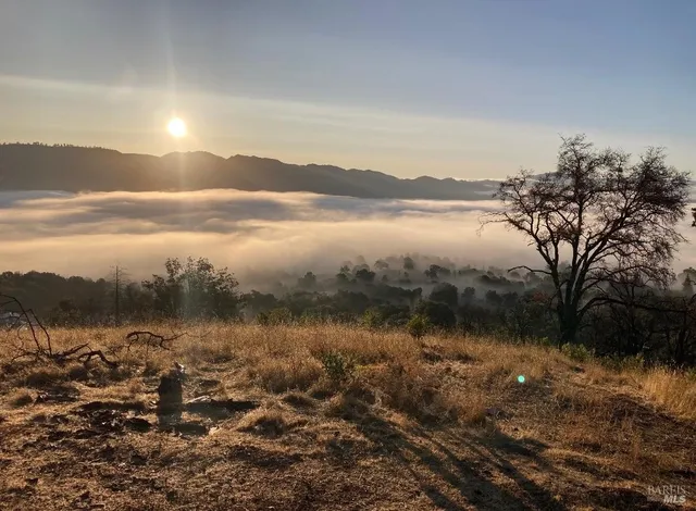 a view of ocean with a mountain