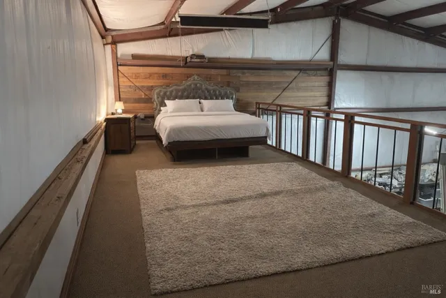 a bedroom with a bed window and deck