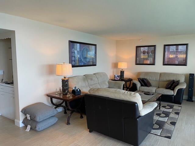 250 South Ocean Boulevard, Unit 11B Boca Raton, FL 33432 - Photo 11 of 47 a living room with furniture a lamp and a window