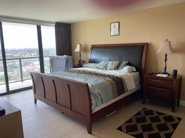 250 South Ocean Boulevard, Unit 11B Boca Raton, FL 33432 - Photo 12 of 47 a bedroom with a bed and wooden floor