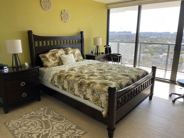 250 South Ocean Boulevard, Unit 11B Boca Raton, FL 33432 - Photo 15 of 47 a bed sitting in a bedroom next to a window