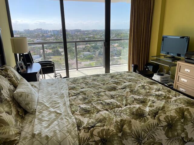 250 South Ocean Boulevard, Unit 11B Boca Raton, FL 33432 - Photo 16 of 47 a bedroom with a bed and large windows