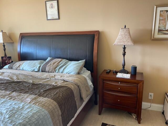 250 South Ocean Boulevard, Unit 11B Boca Raton, FL 33432 - Photo 22 of 47 a bedroom with a bed and a mirror