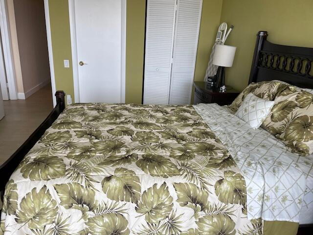 250 South Ocean Boulevard, Unit 11B Boca Raton, FL 33432 - Photo 43 of 47 a bedroom with a bed and wooden floor
