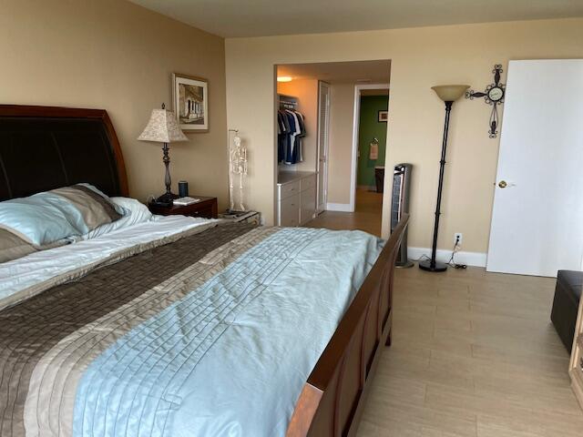 250 South Ocean Boulevard, Unit 11B Boca Raton, FL 33432 - Photo 45 of 47 a bedroom with a bed and a mirror