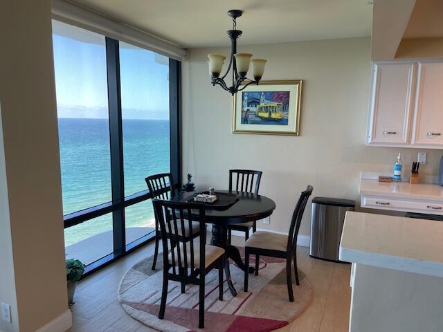 250 South Ocean Boulevard, Unit 11B Boca Raton, FL 33432 - Photo 6 of 47 a view of a dining room with furniture window and wooden floor
