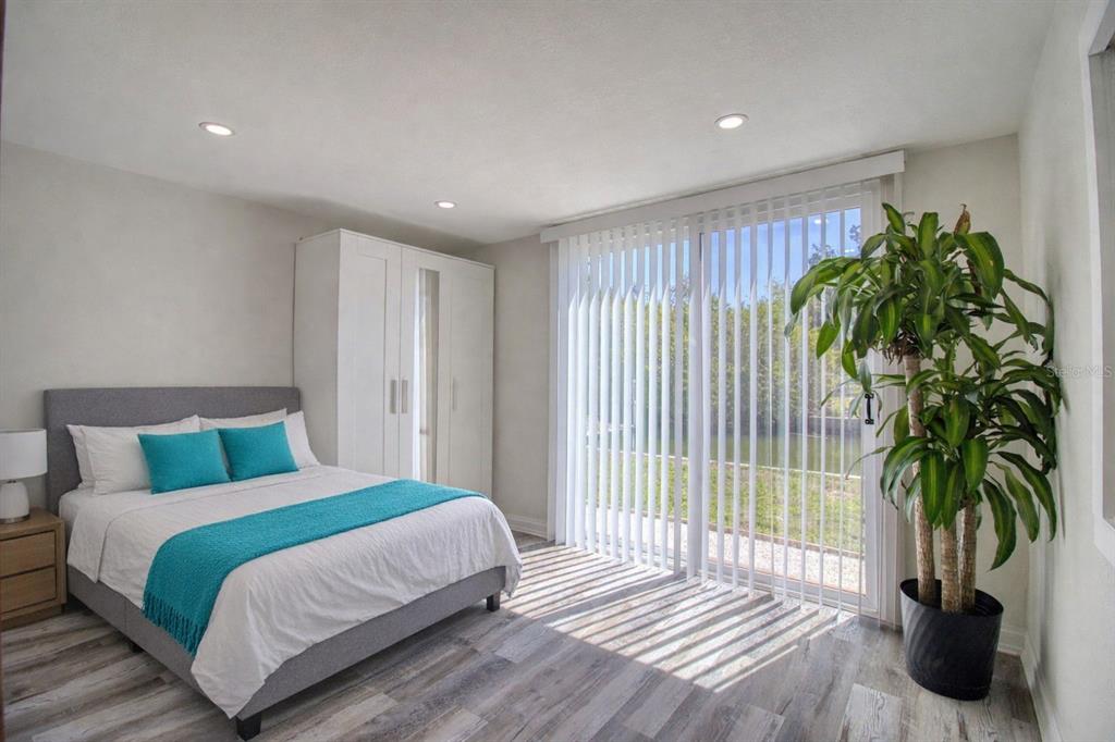 6820 Sea Ranch Drive Hudson, FL 34667 - Photo 11 of 29 a bedroom with a large bed and a potted plant