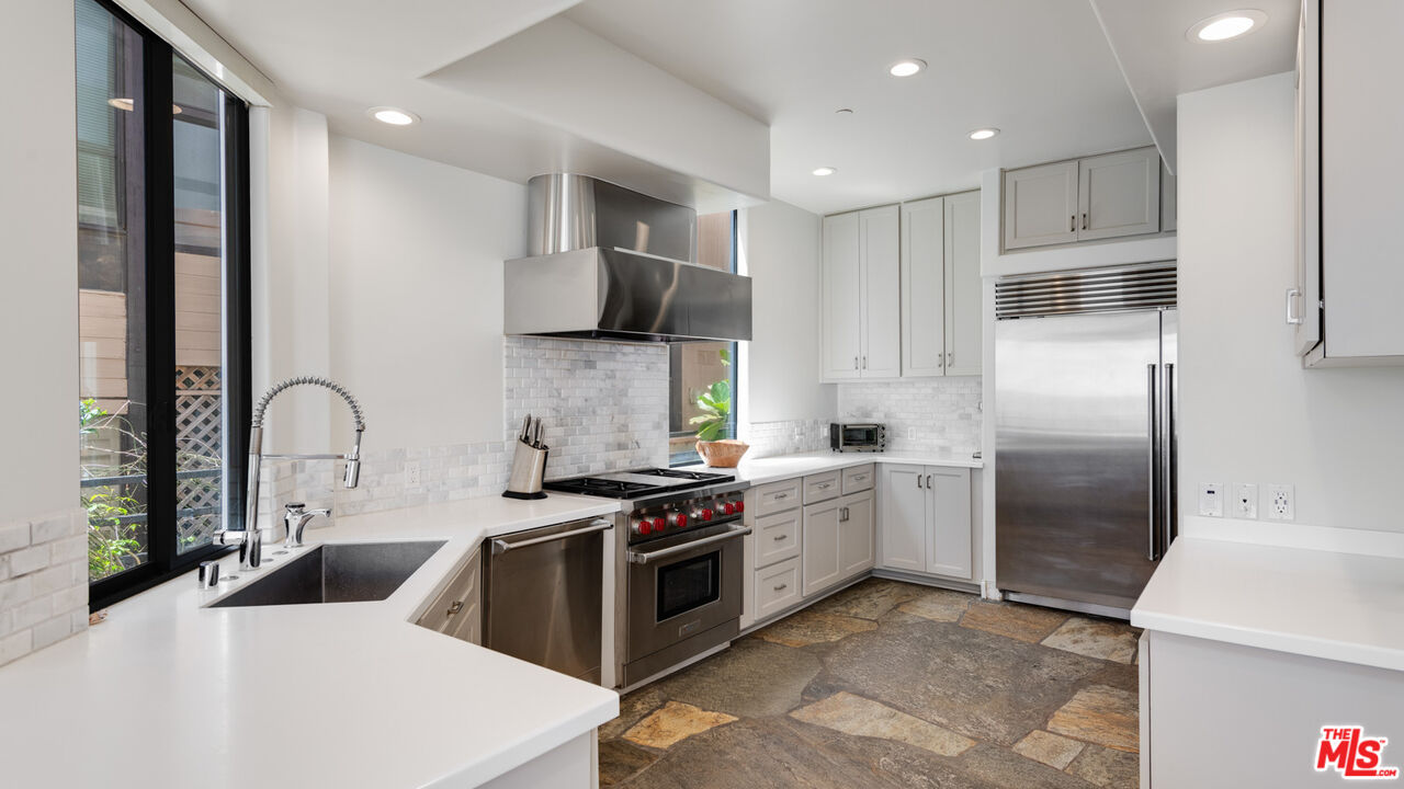 25252 Malibu Road Malibu, CA 90265 - Photo 21 of 62 a kitchen with stainless steel appliances granite countertop a stove a sink and a refrigerator
