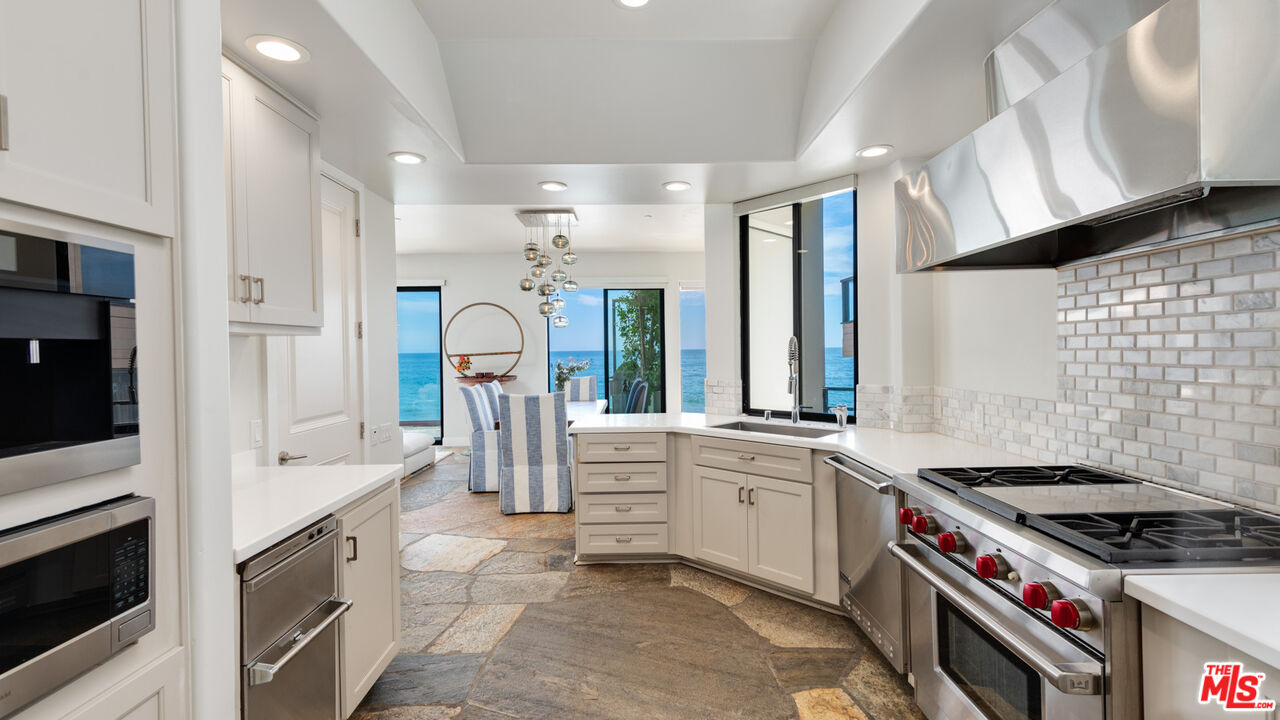 25252 Malibu Road Malibu, CA 90265 - Photo 22 of 62 a kitchen with stainless steel appliances granite countertop a stove and a sink