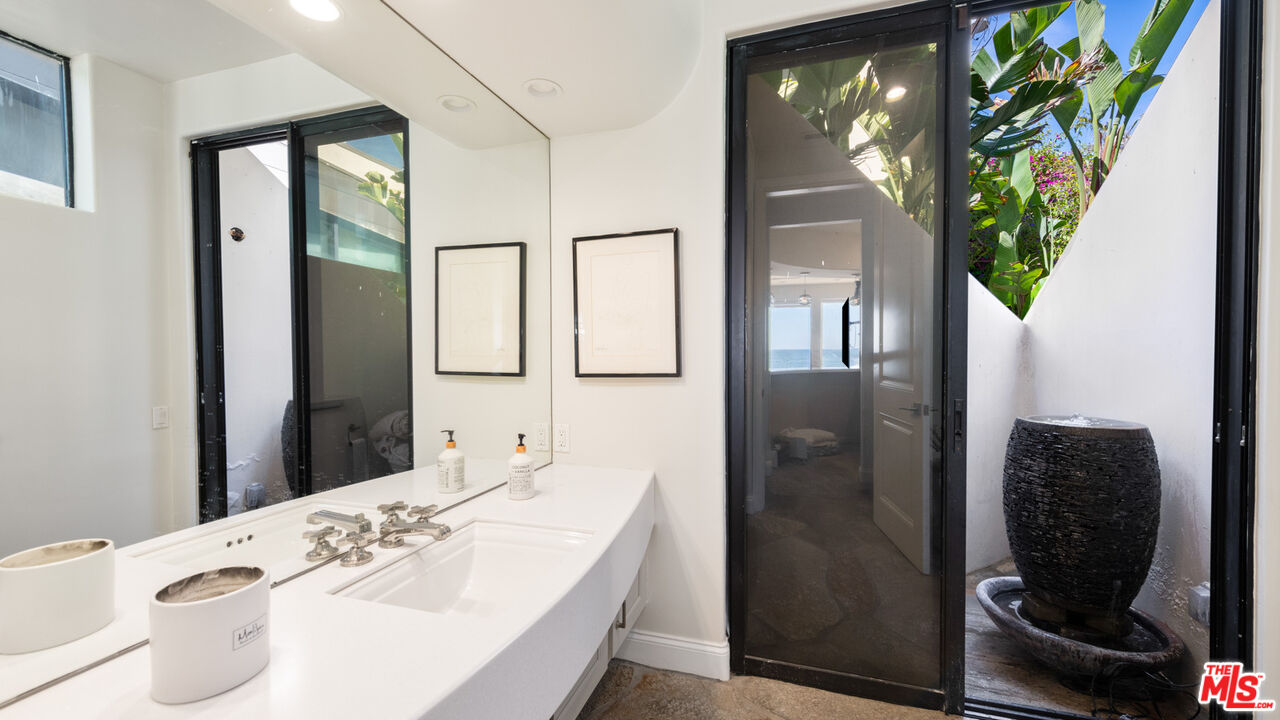 25252 Malibu Road Malibu, CA 90265 - Photo 36 of 62 a bath room with a sink and a mirror