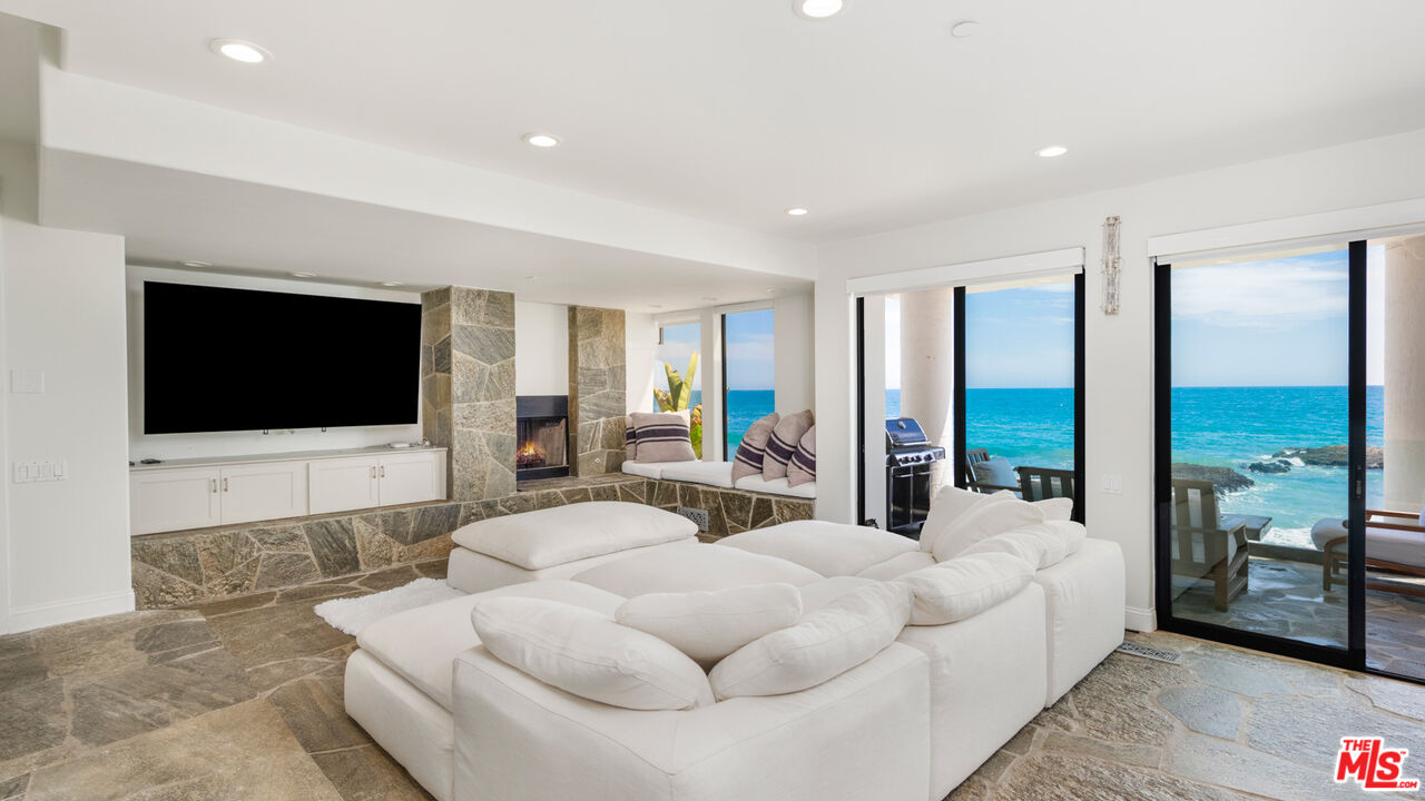 25252 Malibu Road Malibu, CA 90265 - Photo 41 of 62 a living room with furniture and a flat screen tv