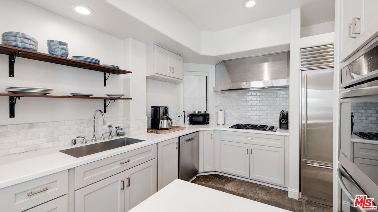 25252 Malibu Road Malibu, CA 90265 - Photo 45 of 62 a kitchen with a sink dishwasher a refrigerator and cabinets