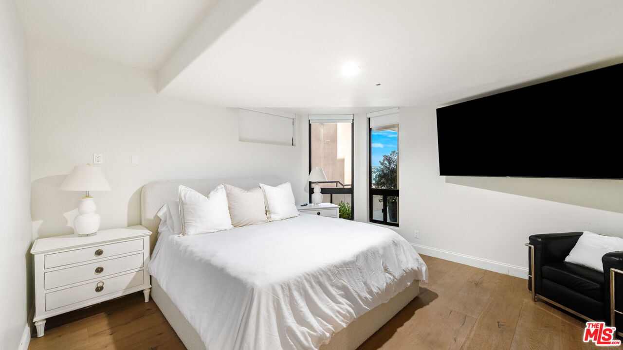 25252 Malibu Road Malibu, CA 90265 - Photo 49 of 62 a bedroom with a bed and a flat screen tv