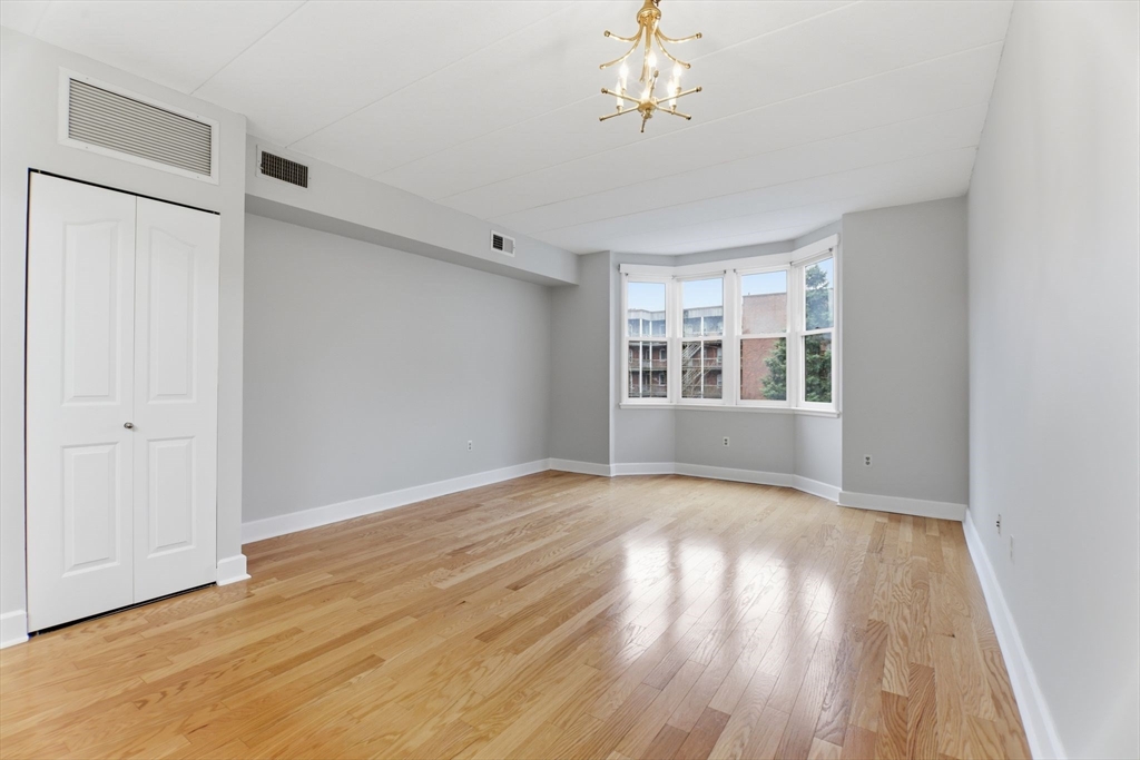 34 Sumner Avenue, Unit 210 Springfield, MA 01108 - Photo 6 of 25 a view of empty room with wooden floor and fan