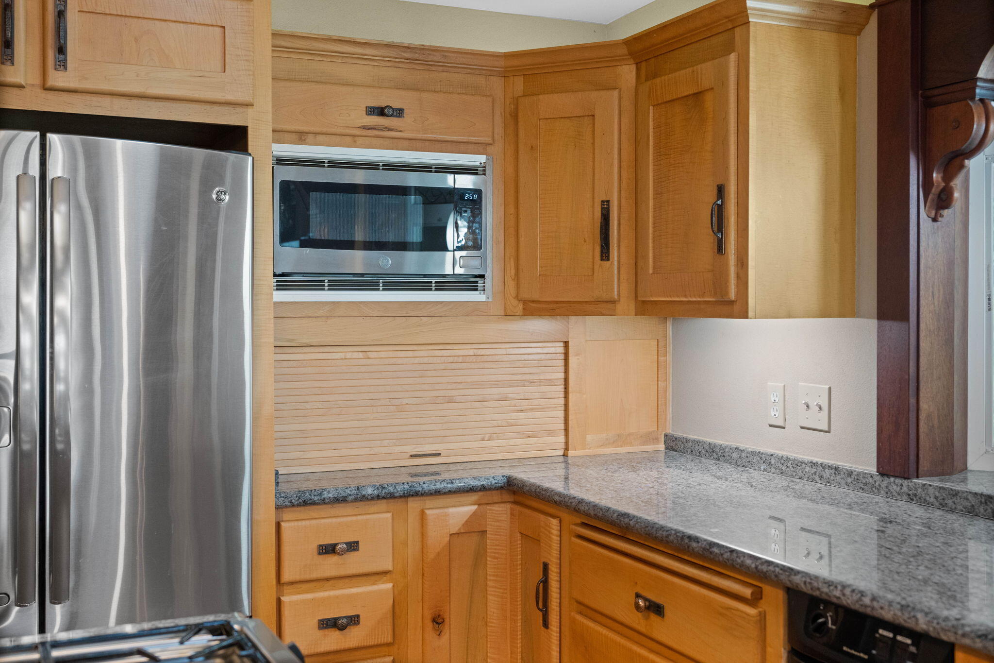 21925 Bear Creek Road Bend, OR 97702 - Photo 29 of 104 a kitchen with granite countertop cabinets stainless steel appliances and a counter space