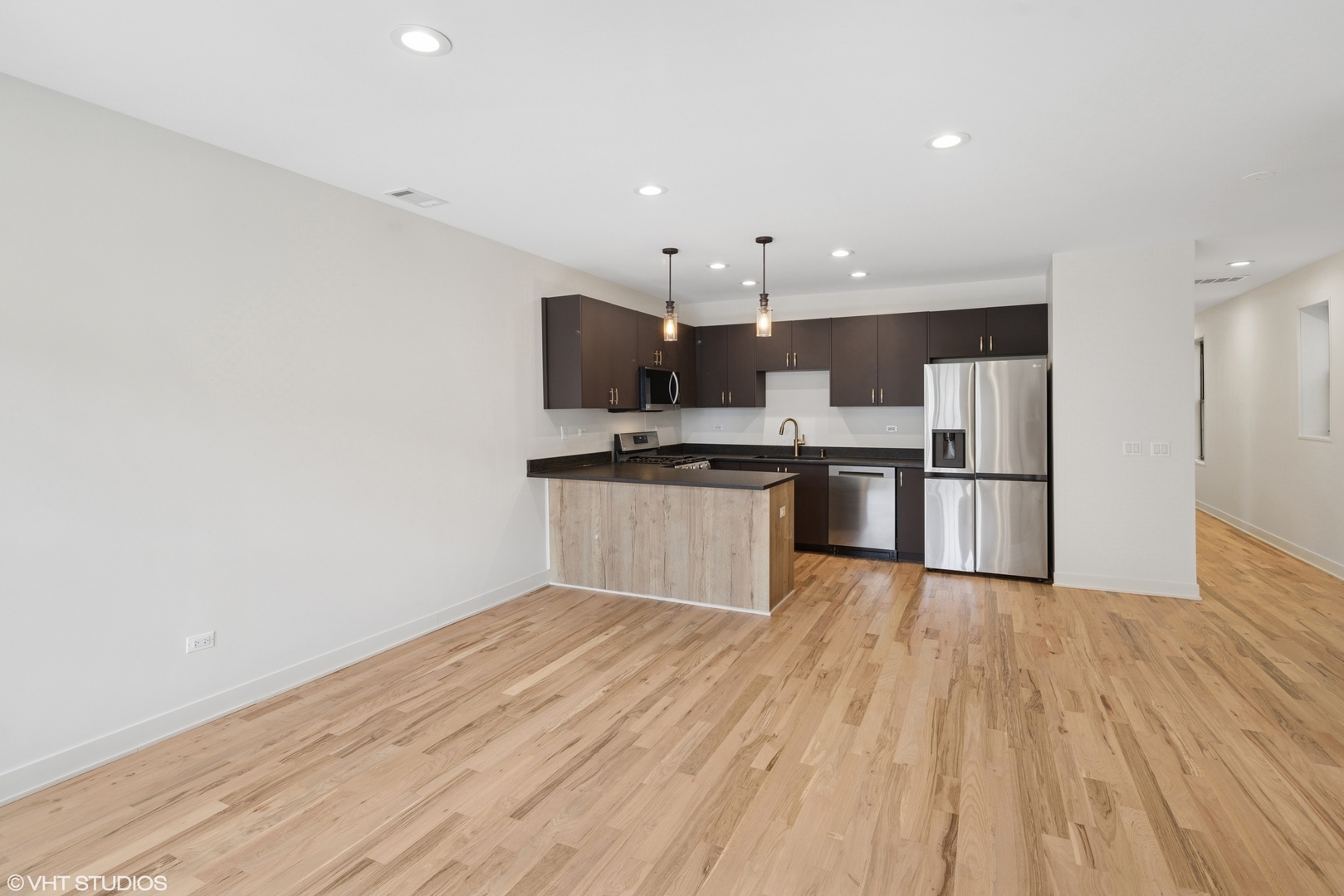 1246 South Fairfield Avenue, Unit 1 Chicago, IL 60608 - Photo 3 of 12 a kitchen with stainless steel appliances a refrigerator and a stove top oven