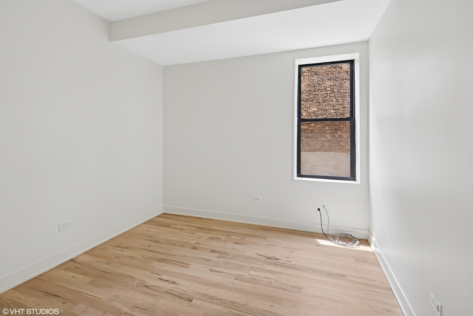 1246 South Fairfield Avenue, Unit 1 Chicago, IL 60608 - Photo 7 of 12 an empty room with a window